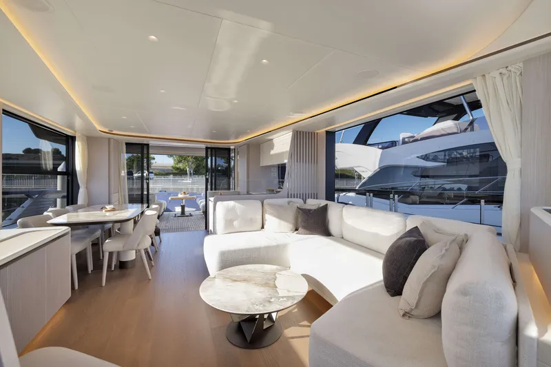 Slide: The Image of Luxurious interior of 2027 Absolute Navetta 62 yacht with modern furnishings and large windows. - 55