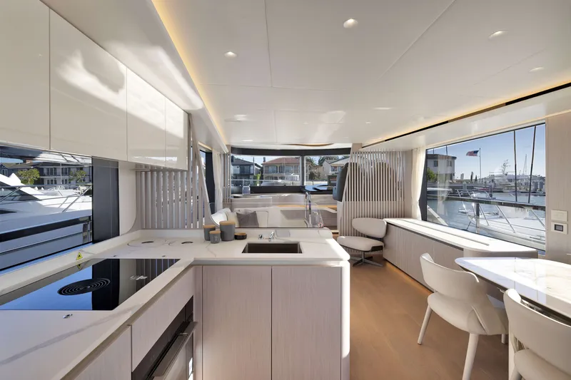 Slide: The Image of Luxurious interior of 2027 Absolute Navetta 62 yacht with modern kitchen and dining area. - 54