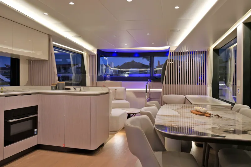 Slide: The Image of Luxurious interior of 2027 Absolute Navetta 62 yacht with modern dining and kitchen area. - 32