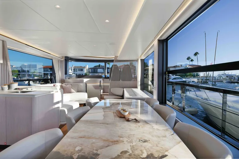 Slide: The Image of Luxurious interior of 2027 Absolute Navetta 62 yacht with elegant dining area and marina view. - 21