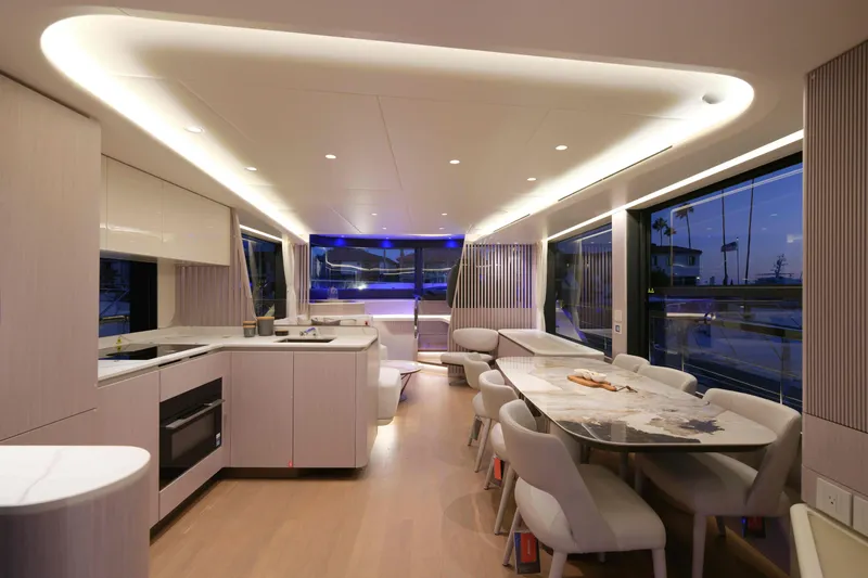 Slide: The Image of Luxurious interior of 2027 Absolute Navetta 62 yacht with modern kitchen and dining area. - 30