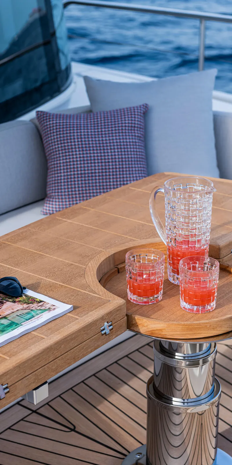 Slide: The Image of Luxury yacht Absolute NAVETTA 75, 2025 model, with drinks on a wooden table. - 12