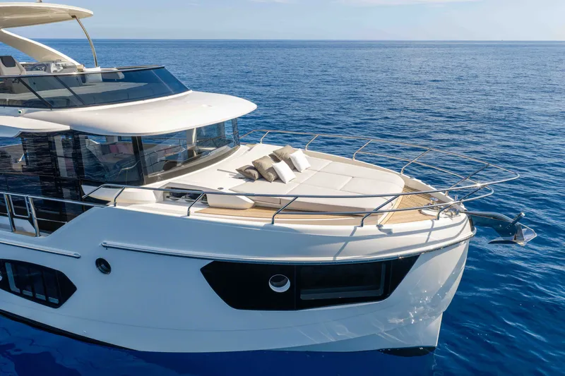 Slide: The Image of Luxurious 2027 Absolute 50 Navetta yacht cruising on serene blue waters. - 11
