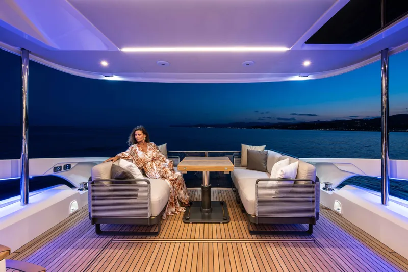Slide: The Image of Luxury yacht Absolute 50 Navetta 2027, elegant woman relaxing on deck at sunset. - 10