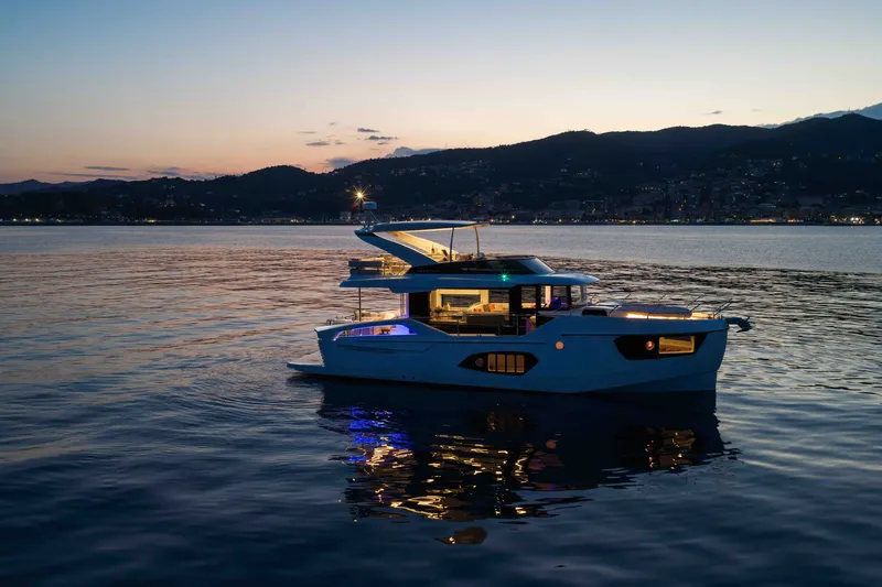 Slide: The Image of Luxury Absolute 50 Navetta yacht at sunset, 2027 model, cruising on serene waters. - 4
