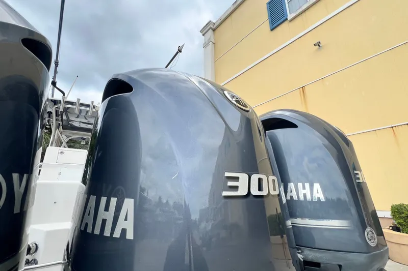 Slide: The Image of Yamaha 300 outboard engines on a 2007 SeaVee 340B Open boat, parked near a building. - 11