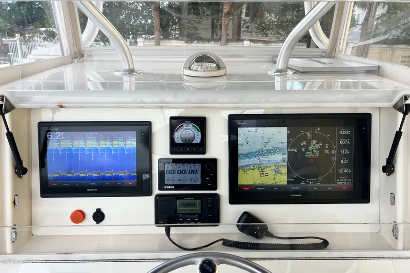 Slide: The Image of Control panel of a 2007 SeaVee 340B Open boat with Garmin navigation displays. - 34