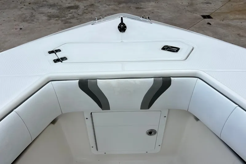 Slide: The Image of 2007 SeaVee 340B Open boat bow with white cushioned seating and storage hatch. - 65