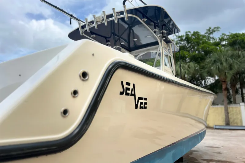 Slide: The Image of 2007 SeaVee 340B Open boat, side view with logo, under cloudy sky. - 2