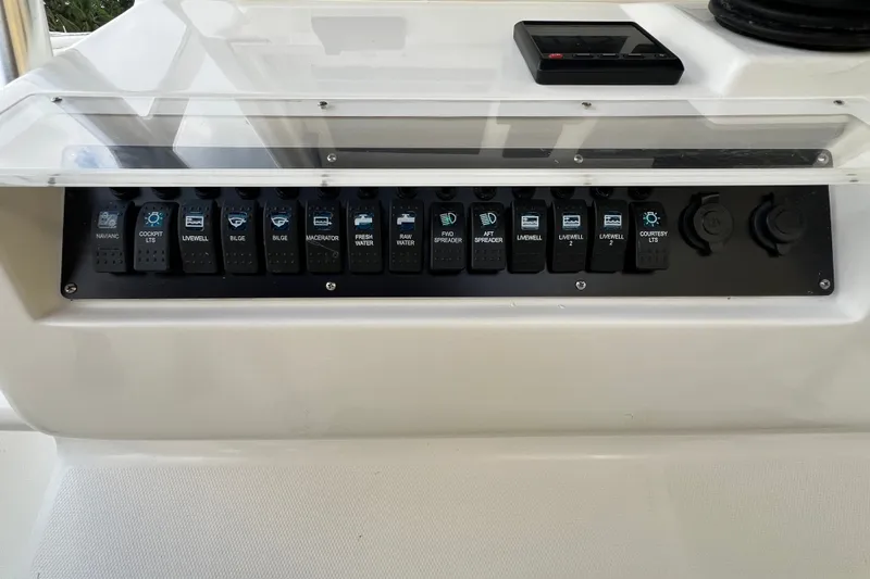 Slide: The Image of Control panel of a 2007 SeaVee 340B Open boat with labeled switches. - 48