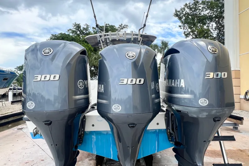 Slide: The Image of 2007 SeaVee 340B Open with triple Yamaha 300 engines, docked outdoors. - 7