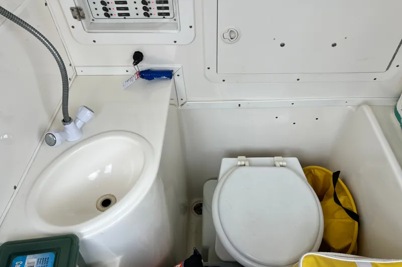 Slide: The Image of 2007 SeaVee 340B Open boat interior with sink, toilet, and storage compartment. - 83