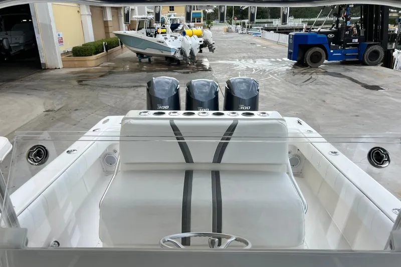 Slide: The Image of 2007 SeaVee 340B Open boat with triple 300 horsepower engines at a marina. - 98