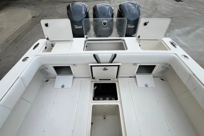 Slide: The Image of 2007 SeaVee 340B Open boat deck with triple 300 horsepower engines, storage compartments, and seating. - 107