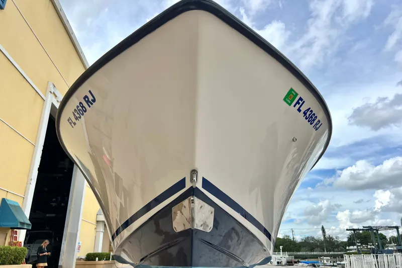 Slide: The Image of 2007 SeaVee 340B Open boat docked, showcasing its sleek hull design against a cloudy sky. - 21