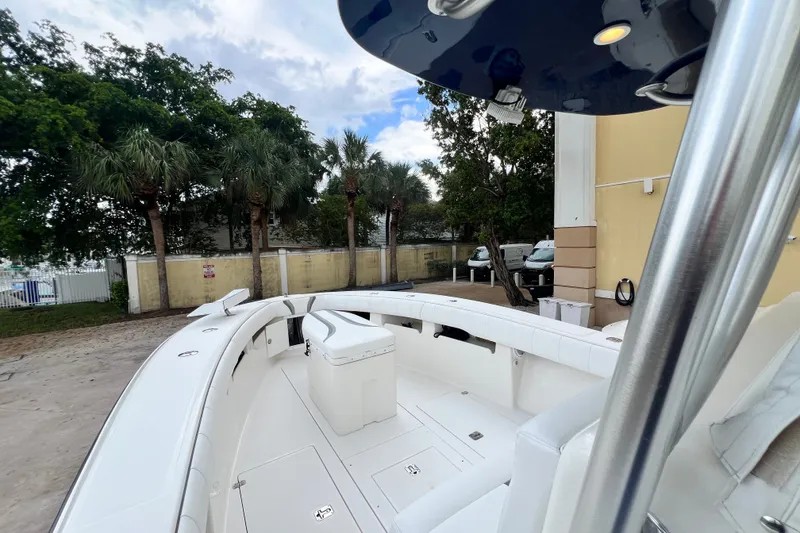 Slide: The Image of 2007 SeaVee 340B Open boat with spacious deck, surrounded by palm trees and parked vehicles. - 70