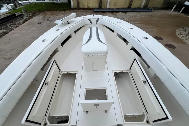 Slide: The Image of 2007 SeaVee 340B Open boat deck with open storage compartments and cushioned seating. - 93