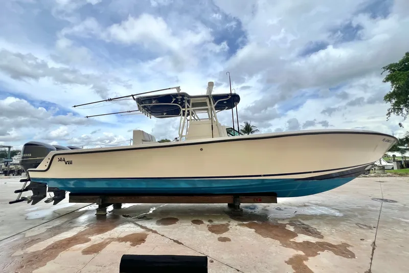Slide: The Image of 2007 SeaVee 340B Open boat on a dock, under a cloudy sky. - 1