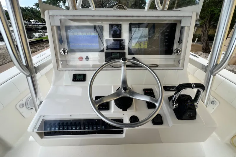 Slide: The Image of 2007 SeaVee 340B Open boat helm with steering wheel, controls, and navigation screens. - 32