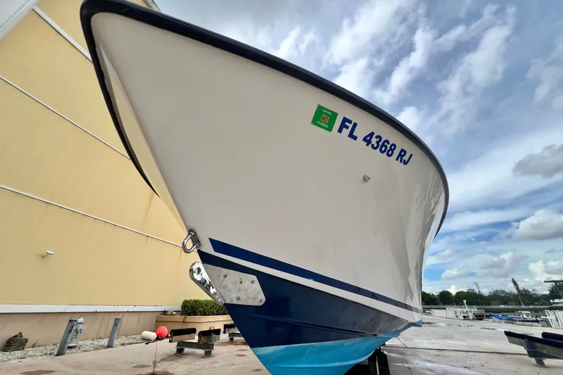 Slide: The Image of 2007 SeaVee 340B Open boat with Florida registration, docked under a cloudy sky. - 20