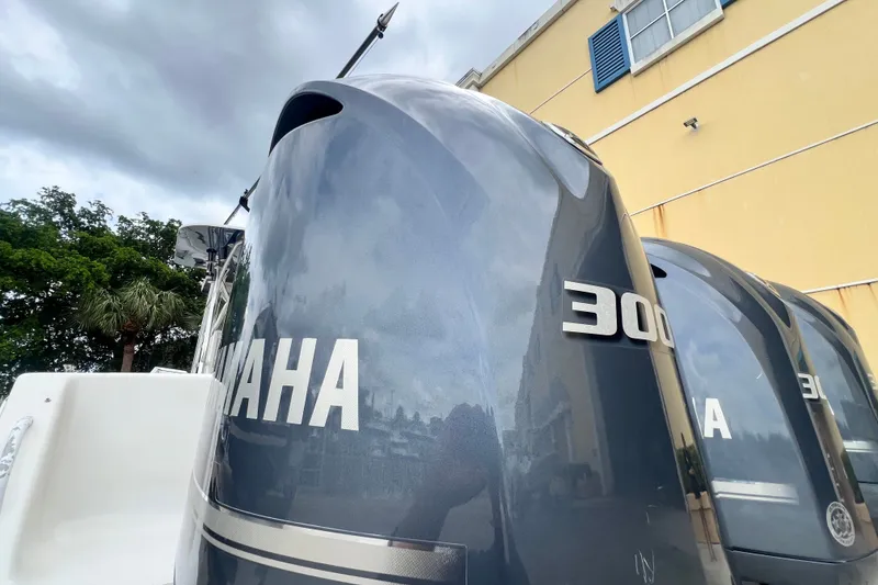 Slide: The Image of Yamaha 300 outboard engines on a 2007 SeaVee 340B Open boat, cloudy sky background. - 13