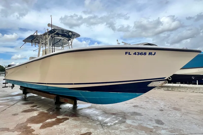 The Image of 2007 SeaVee 340B Open boat on dry dock, featuring a sleek white and blue design. - 0