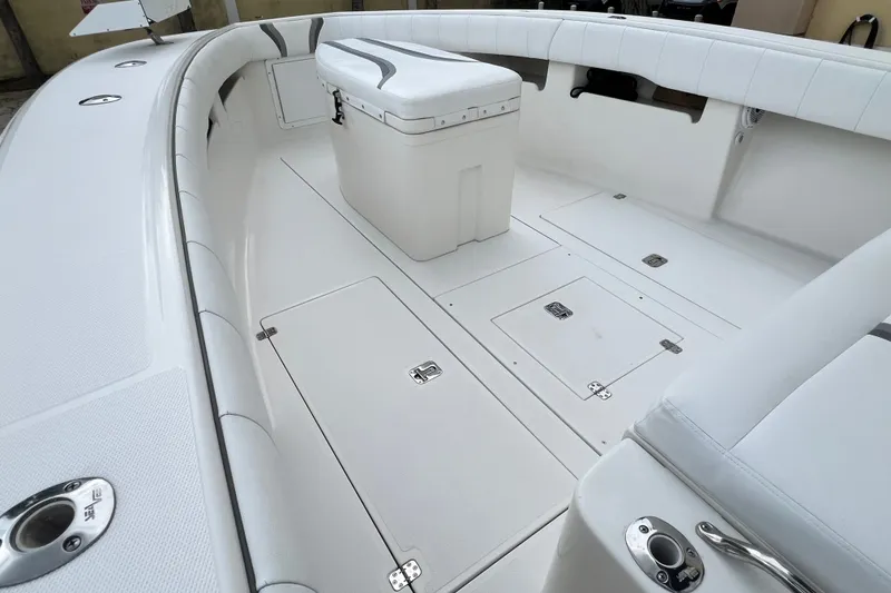 Slide: The Image of 2007 SeaVee 340B Open boat interior with white seating and storage compartments. - 74