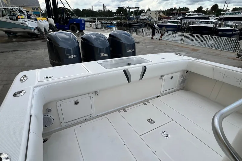 Slide: The Image of 2007 SeaVee 340B Open boat with triple 300 horsepower engines at a marina. - 103