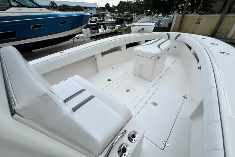 Slide: The Image of 2007 SeaVee 340B Open boat interior with white seating and storage compartments. - 62