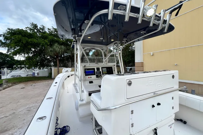 Slide: The Image of 2007 SeaVee 340B Open boat with modern console and rod holders, docked outdoors. - 56