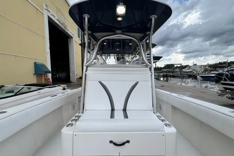Slide: The Image of 2007 SeaVee 340B Open boat interior with white seating, docked near marina. - 80
