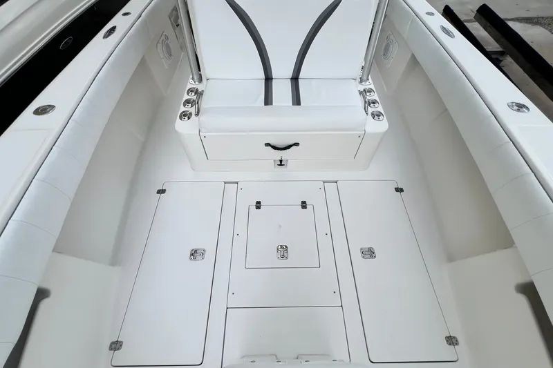 Slide: The Image of 2007 SeaVee 340B Open boat interior with white seating and storage compartments. - 87