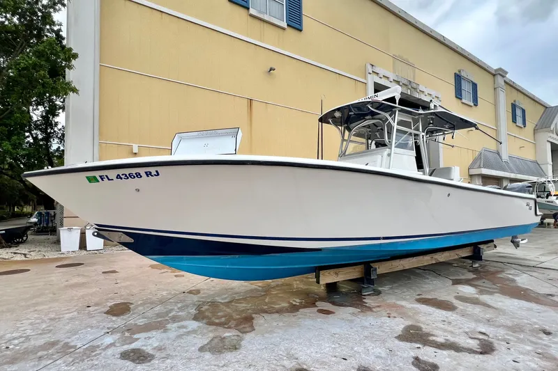 Slide: The Image of 2007 SeaVee 340B Open boat on display, white hull with blue accents, docked outdoors. - 19