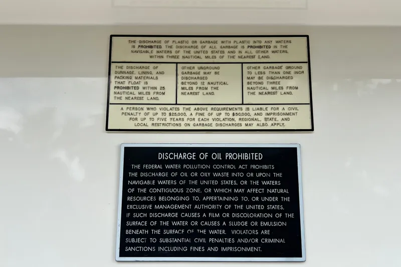 Slide: The Image of Warning signs on a 2007 SeaVee 340B Open boat about prohibited waste discharge. - 85