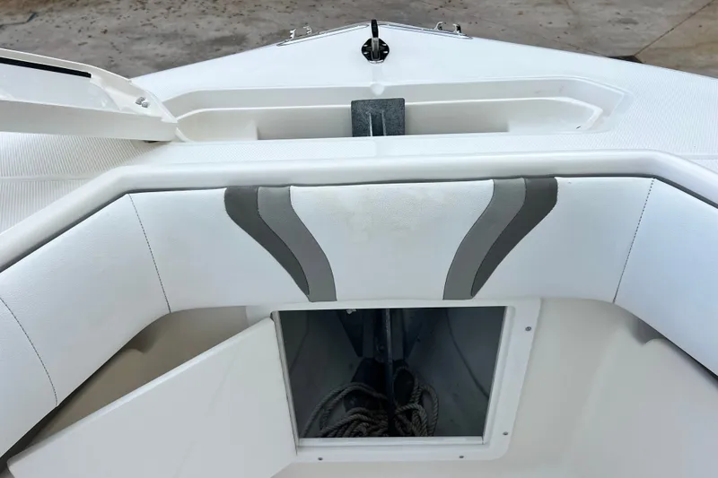 Slide: The Image of 2007 SeaVee 340B Open boat interior with white cushioned seating and storage compartment. - 66
