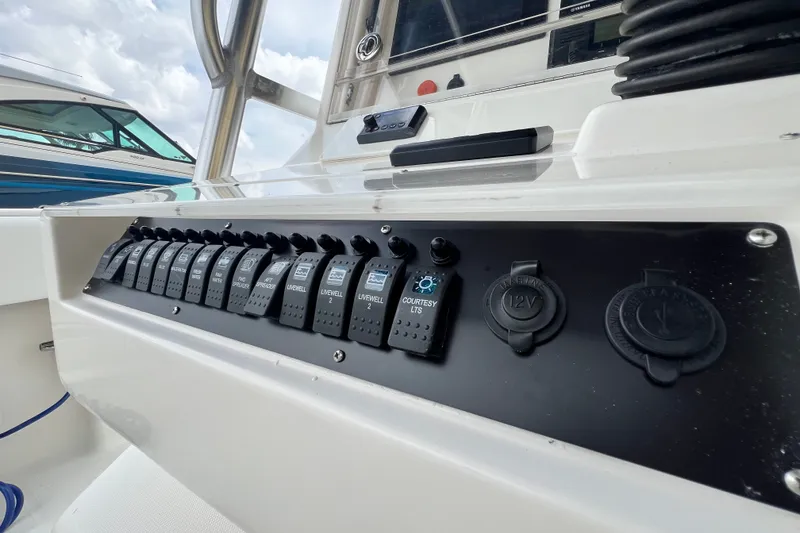 Slide: The Image of Control panel of a 2007 SeaVee 340B Open boat with labeled switches and outlets. - 40