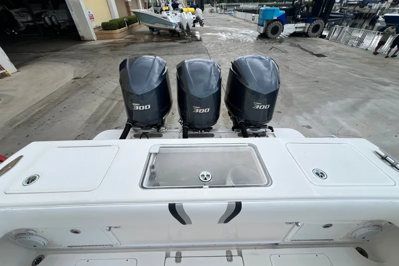 Slide: The Image of 2007 SeaVee 340B Open boat with triple Yamaha 300 engines at a marina. - 112