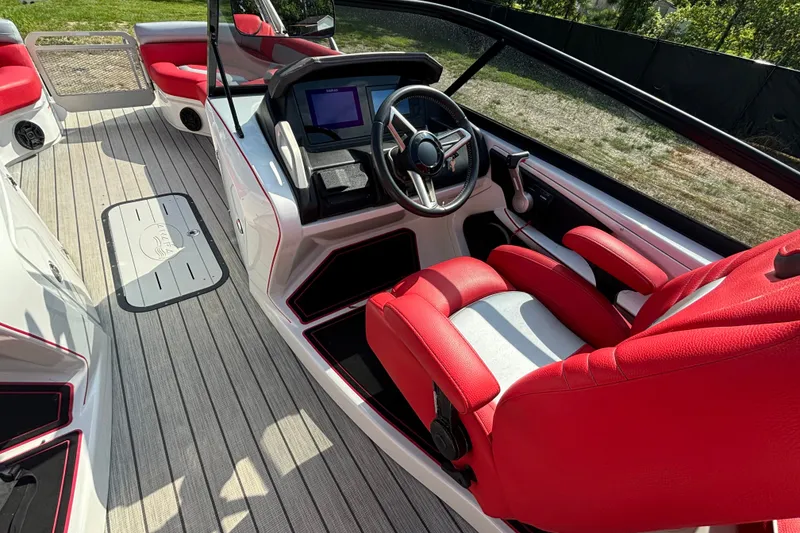 Slide: The Image of Red and white interior of a 2021 Amara pontoon boat with modern dashboard. - 10