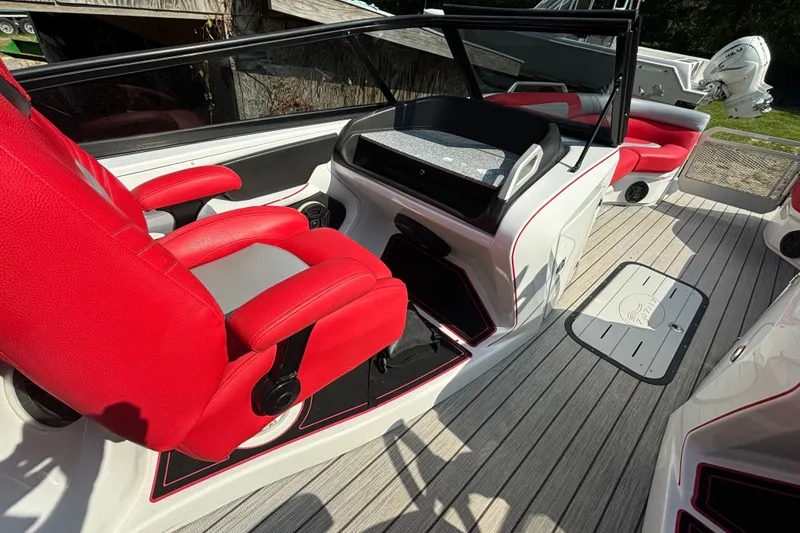 Slide: The Image of 2021 Amara pontoon boat interior with red seats and modern dashboard design. - 11