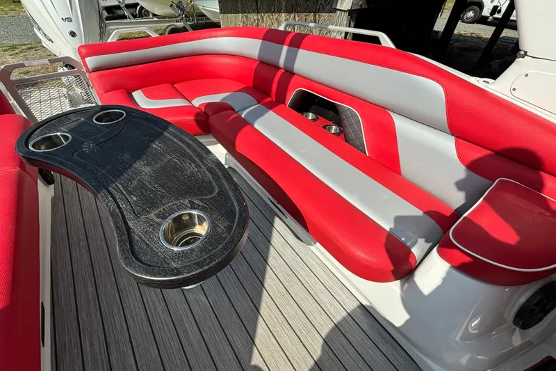 Slide: The Image of Red and gray seating on 2021 Amara pontoon boat with cupholders and table. - 12
