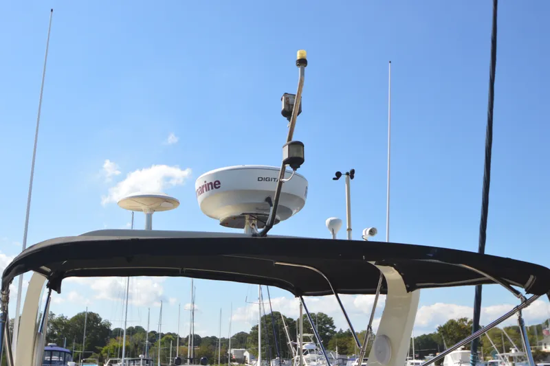 Slide: The Image of Radar equipment on a 2012 North Pacific Yachts 43 under a clear blue sky. - 31