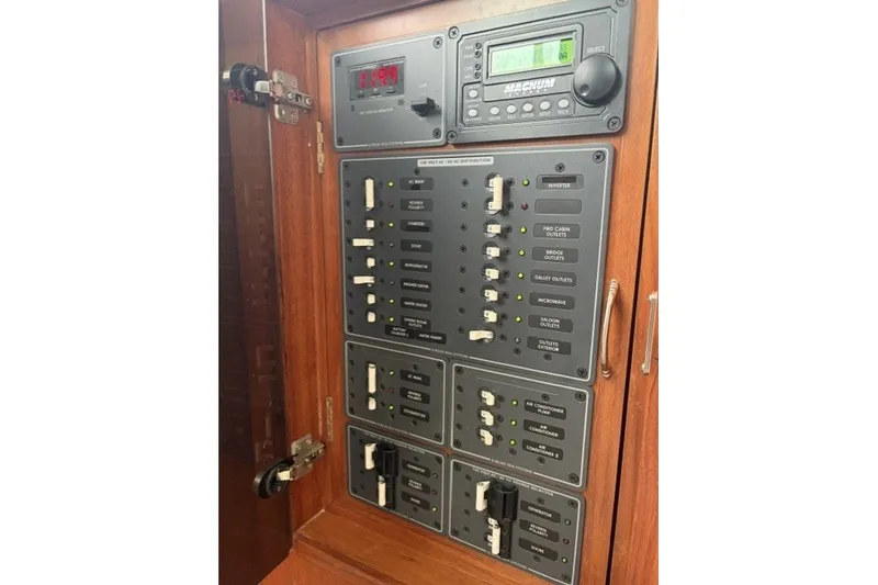 Slide: The Image of Electrical control panel on a 2012 North Pacific Yachts 43, featuring various switches and indicators. - 15