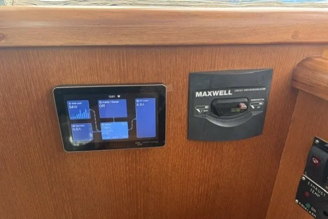 Slide: The Image of Control panel of a 2012 North Pacific Yachts 43, featuring digital displays and Maxwell circuit breaker. - 16