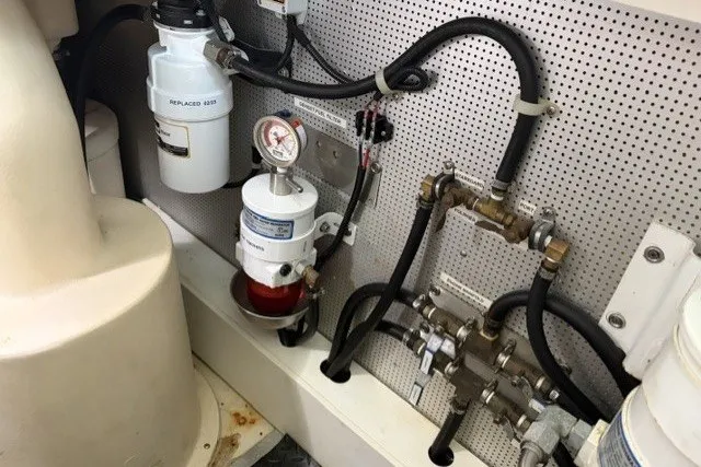 Slide: The Image of Engine room of 2012 North Pacific Yachts 43, showcasing fuel filtration system and plumbing components. - 96