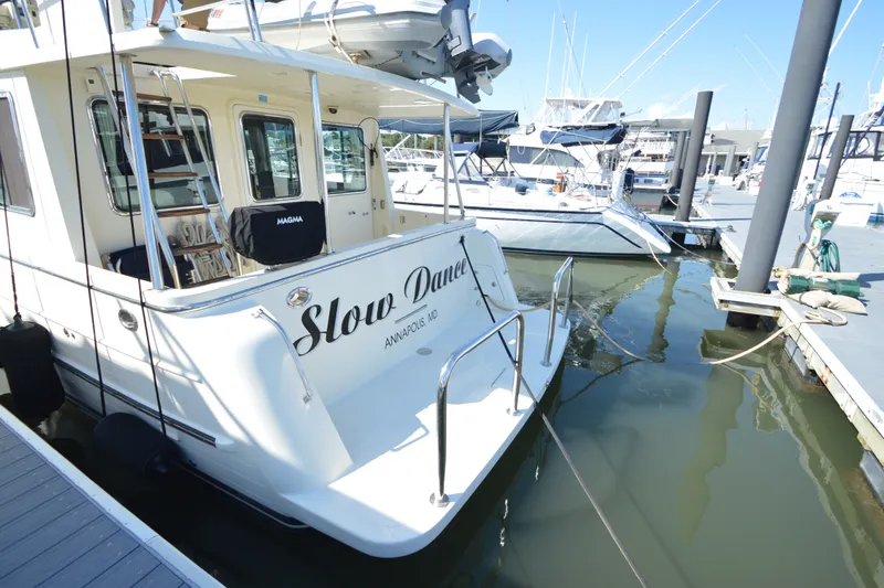 Slide: The Image of North Pacific Yachts 43, 2012 model, docked at marina, named "Slow Dance." - 51