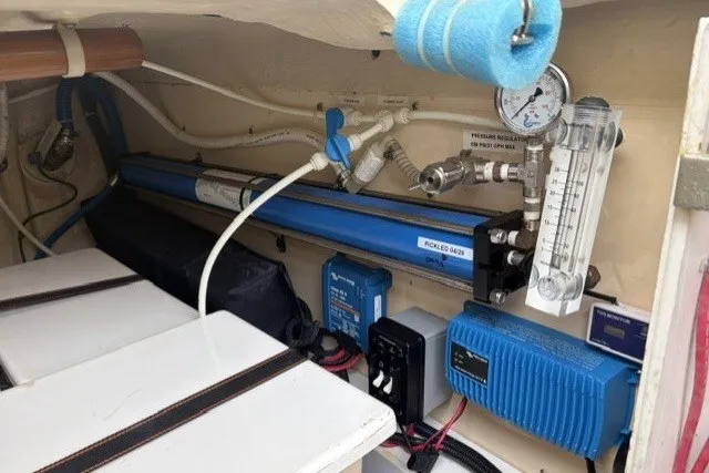 Slide: The Image of Engine room of 2012 North Pacific Yachts 43, featuring mechanical equipment and gauges. - 105