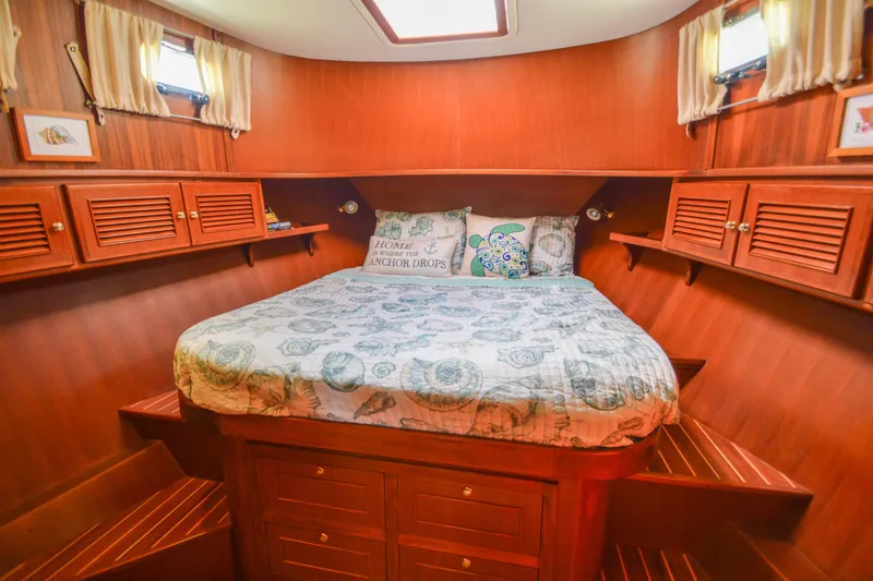 Slide: The Image of Cozy cabin interior of 2012 North Pacific Yachts 43 with wooden finish and comfortable bedding. - 13