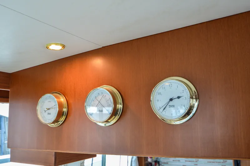 Slide: The Image of Wall-mounted instruments on 2012 North Pacific Yachts 43, featuring clock, barometer, and thermometer. - 66