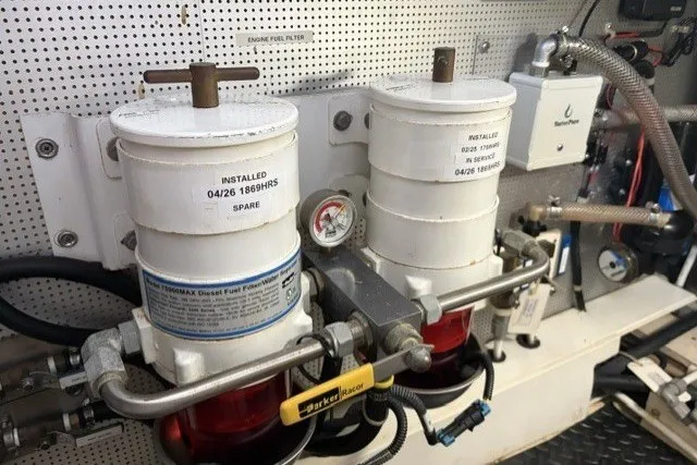Slide: The Image of Engine room of 2012 North Pacific Yachts 43, featuring dual diesel fuel filters. - 93