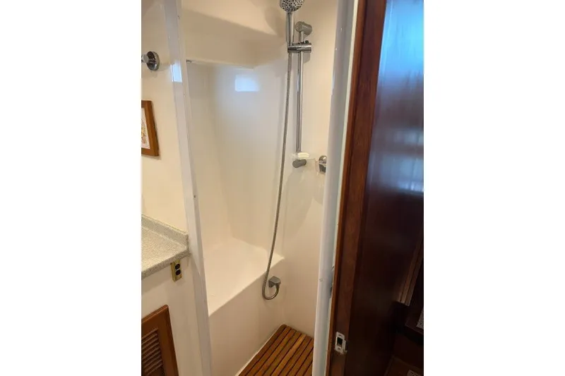 Slide: The Image of Shower area in 2012 North Pacific Yachts 43, featuring sleek design and wooden flooring. - 25